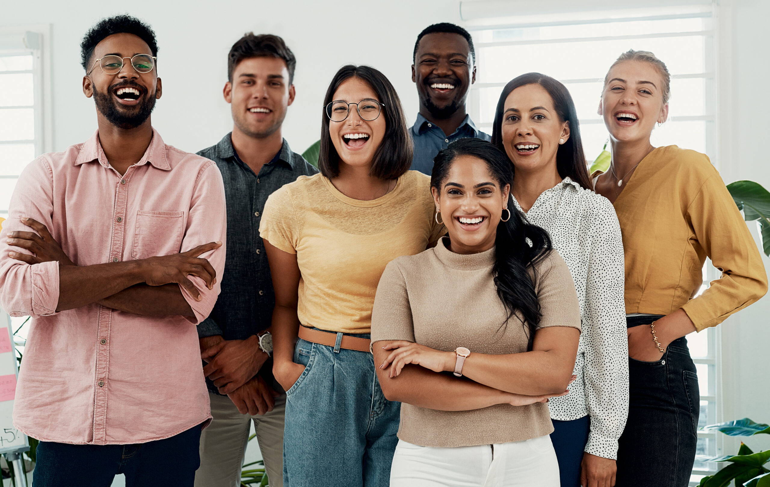Cropped portrait of a diverse group businesspeople standing together after a successful discussion in the office.